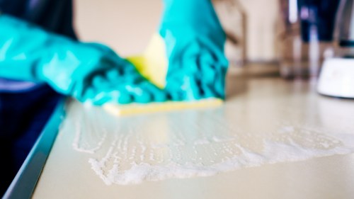 Team member using safe carpet cleaning procedures indoors