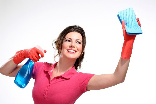 Cleaner vacuuming carpets in a SW3 flat at move-out