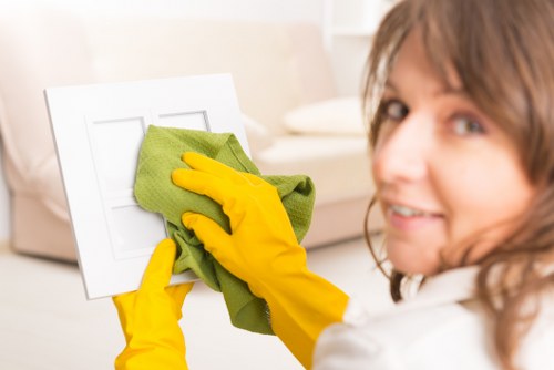 Office cleaners in SW3 polishing meeting room surfaces and glass partitions
